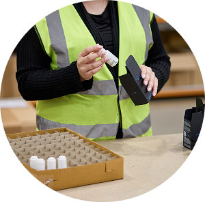 Staff member inspecting products in a warehouse, reflecting quality control in fulfilment services UK by Future Pro Logistics