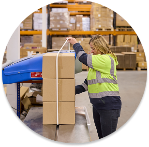 Female warehouse worker carrying boxes, showcasing hands-on fulfilment services and expert logistics support by Future Pro Logistics in the UK