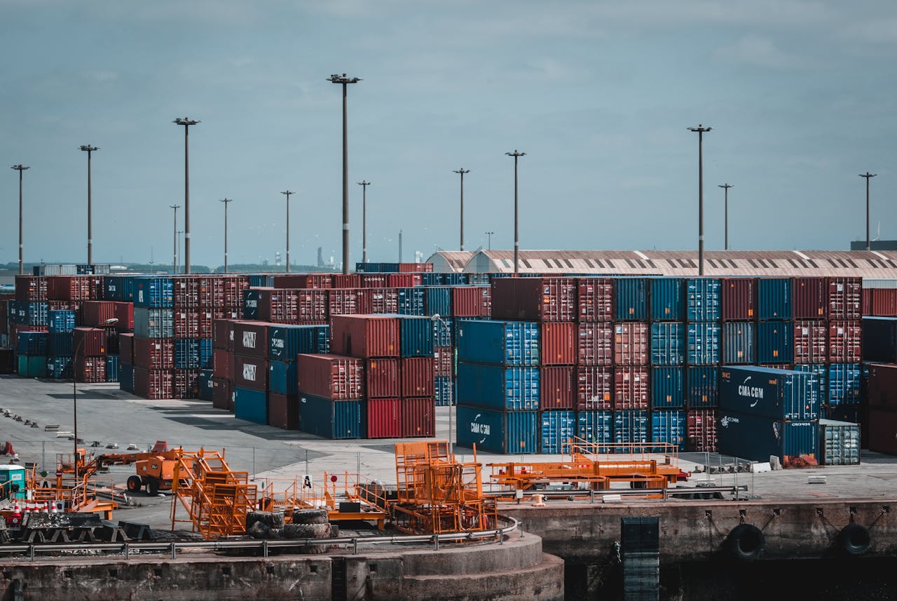 Stacked shipping containers at a UK port terminal, representing global logistics and international freight services by Future Pro Logistics